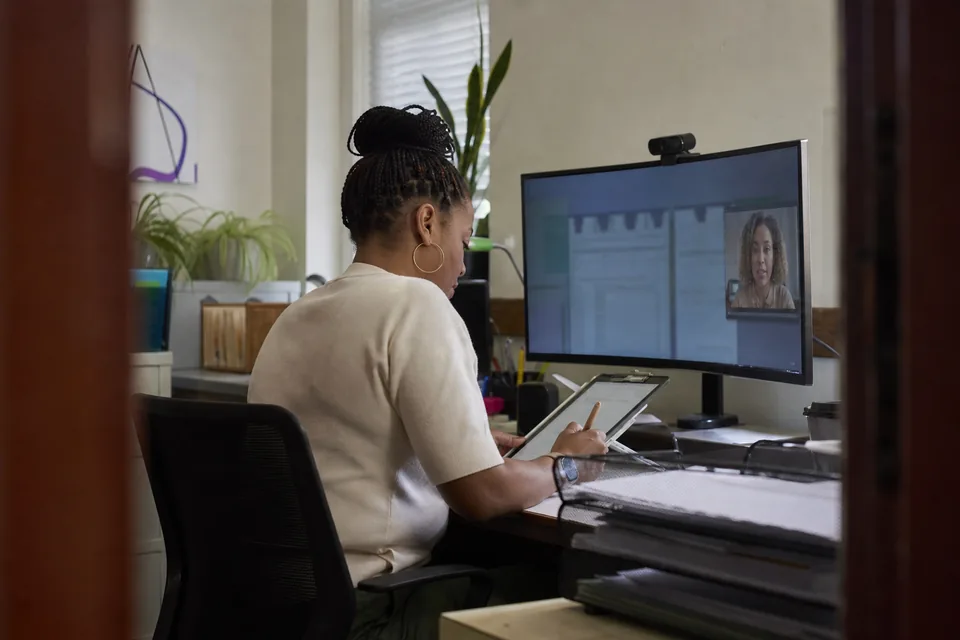 Onboarding specialist collecting signed forms and files from a new customer in one plan