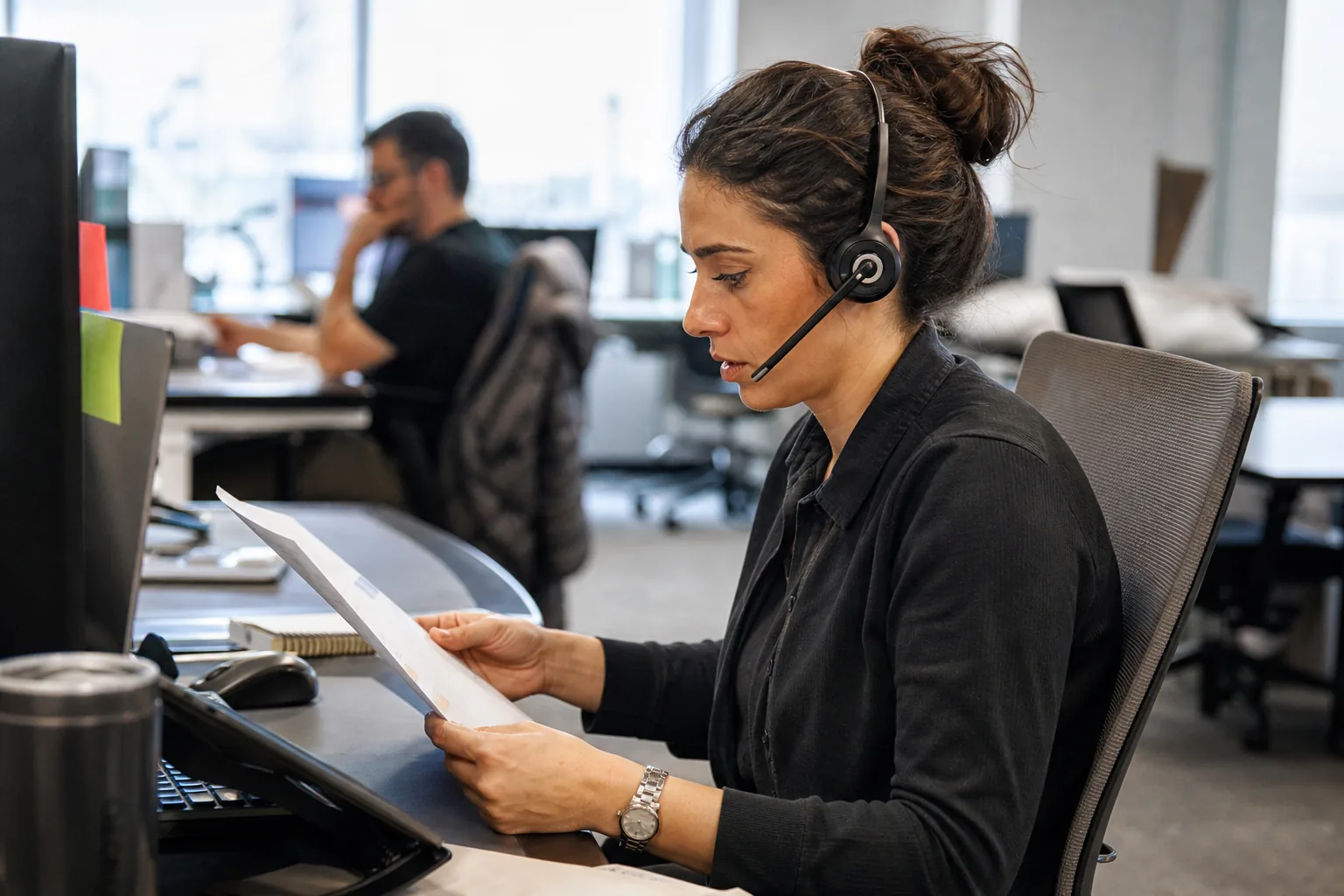 Customer success manager reading an account handoff brief before a first call